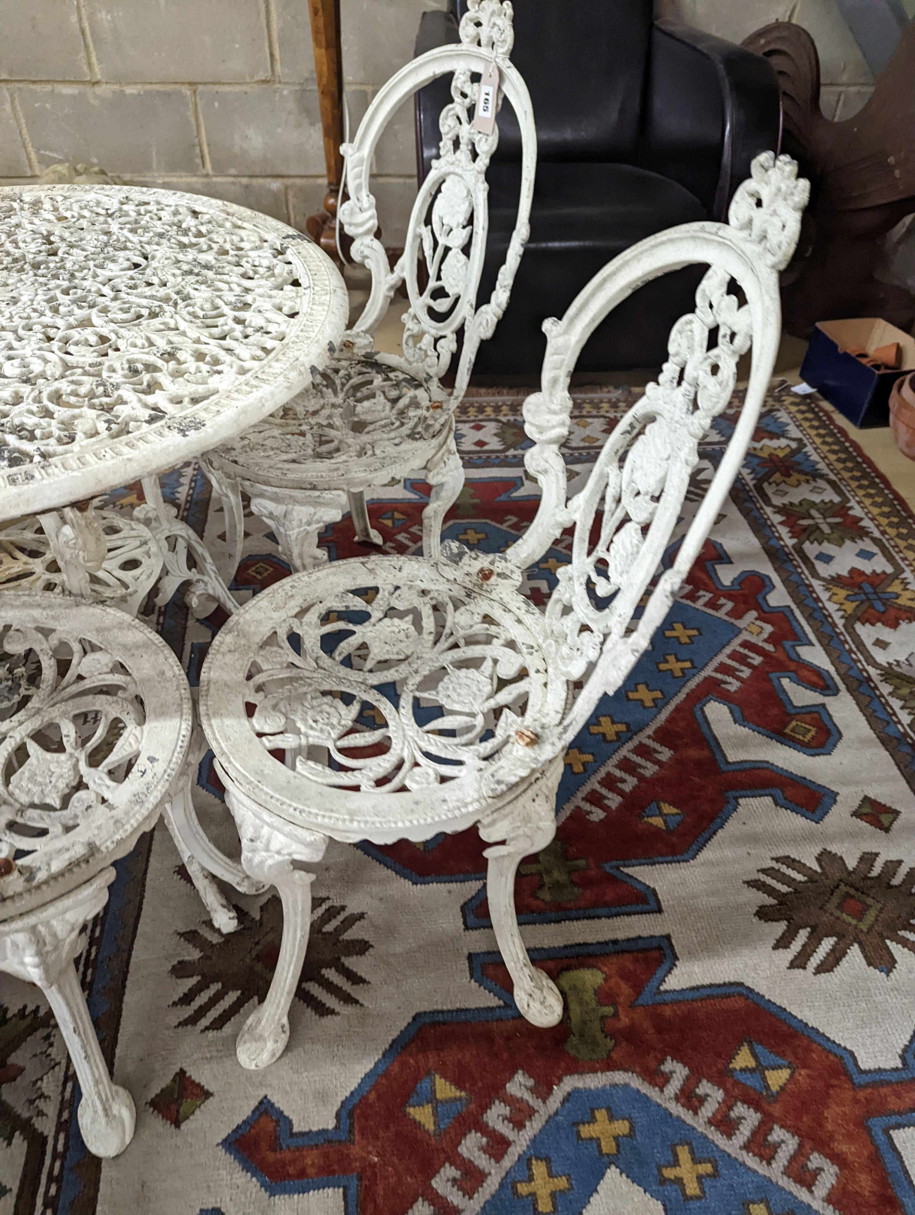 A Victorian style painted aluminium circular garden table, diameter 72cm, together with four chairs